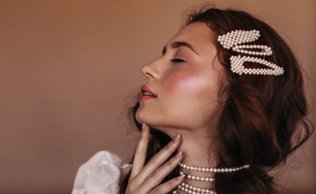 portrait-of-graceful-woman-with-freckles-gently-touching-neck-dark-haired-girl-with-hairpins-and